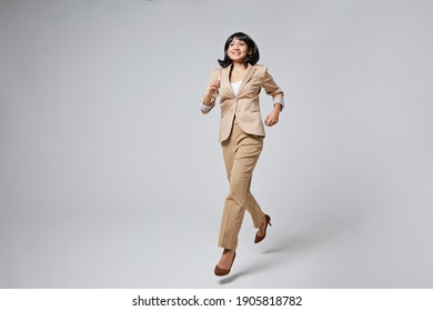 A Indonesian Woman Running In A Suit