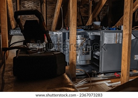 An indoor air handler being installing in the attic. This is a heat pump with emergency back up electric heat.  