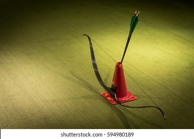 Indoor Archery Range, Bow And Three Green Fletched Arrows Stand Ready For Shooting