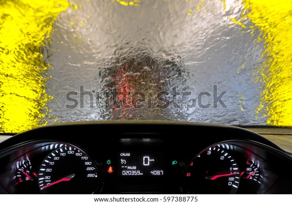Indoor car\
wash with the view from the Driver\
seat.