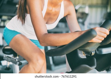 Indoor Cycling Woman Doing HIIT Cardio Workout Biking On Indoors Gym Bike. Girl Cyclist Working Out Interval Training On Bicycle. Closeup Of Legs And Thighs For Fat Weight Loss.