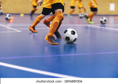 Indoor Football Training For Youth Team. Young Boys With Soccer Balls Running On Wooden Parquet. Indoor Football Soccer School Practice. Kids In Soccer Sportswear