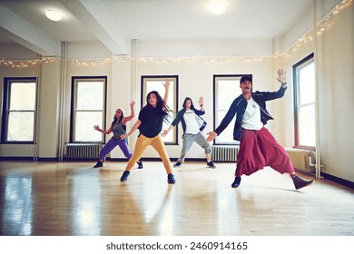 Indoor, hip hop and group of dancers for rehearsal, breakdance or action together for performance. Inside, practice or freestyle of talented people with skill, exercise or energy for entertainment - Powered by Shutterstock