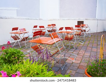 Indoor outdoor café, wooden tables and chairs on a European street - Powered by Shutterstock