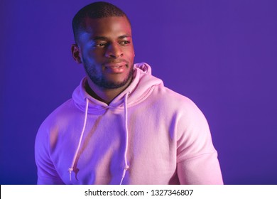 Indoor portrait of afro american guy, dressed in white hooded sweatshirt isolated on purple studio background. Sports and Street Fashion. - Powered by Shutterstock