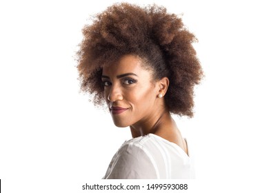 Indoor portrait of afro hair black brazilian girl sideways feeling happy and carefree. Standing against white background. Isolated on white background.