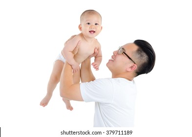 Indoor Portrait Of Asian Father Picking Up His Baby Boy