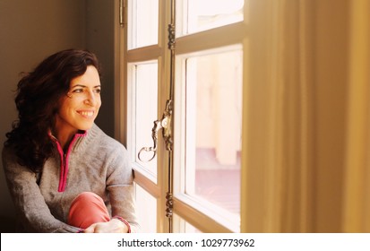 Indoor Portrait Of Beautiful 45 Years Old Woman Next To The Window