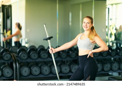 Indoor Portrait Of Happy Young Fit Woman Posing In Gym, Holding Barbell, Healthy Lifestyle Photo