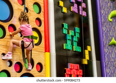 indoor portrait of a young child climbing up - Powered by Shutterstock