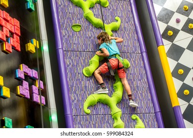 indoor portrait of a young child climbing up - Powered by Shutterstock