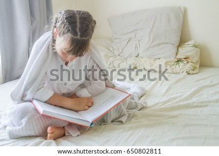 Similar – young caucasian little boy playing with tablet on couch