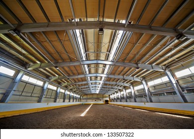 Indoor Riding Hall With Sandy Covering.