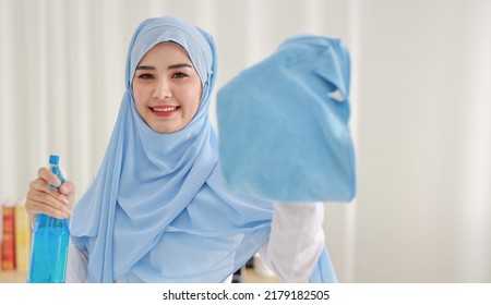 Indoor Shot Active Young Beautiful Asian Housewife Woman Holding Cleaning Spray, Washing Table. Portrait Cute Girl With Happy Emotional Cleaning Bedroom In New Apartment After Moved In. 