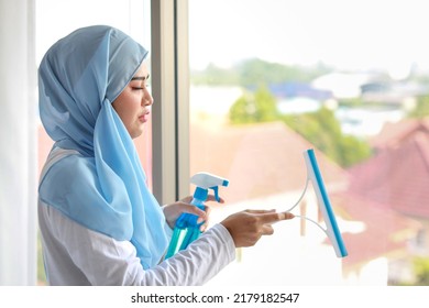 Indoor Shot Active Young Beautiful Asian Housewife Woman Holding Cleaning Spray, Washing Table. Portrait Cute Girl With Happy Emotional Cleaning Bedroom In New Apartment After Moved In.