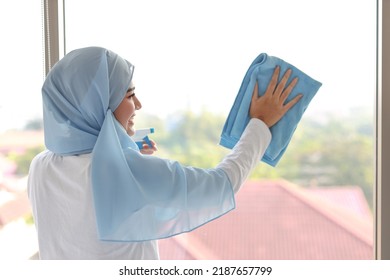 Indoor Shot Active Young Beautiful Asian Housewife Woman Holding Cleaning Spray, Washing Window Glass. Portrait Cute Girl With Happy Emotional Cleaning Bedroom In New Apartment After Moved In. 