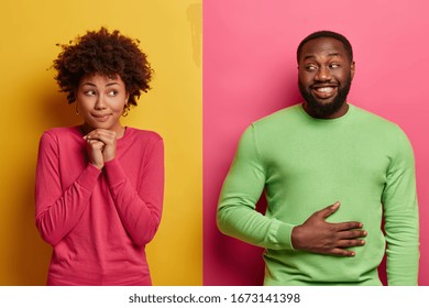 Indoor Shot Of Pretty Woman Gazes With Dreamy Expression Aside, Keeps Hand Under Chin, Happy Bearded Man Satisfied After Eating Supper, Keeps Hands On Stomach, Feels Satiety, Being In Good Mood