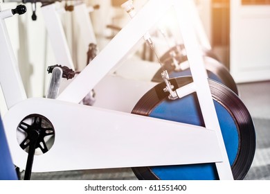 Indoor Stationary Bikes For Spinning Cycling Classes. Spinning Class With Empty Bikes. Close Up Of Gym Bikes.