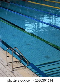  Indoor Swimming Pool. Ropes Divide The Swimming Lanes Of An Indoor Pool Ahead Of A Swim Meet Inside A Sports Arena                              