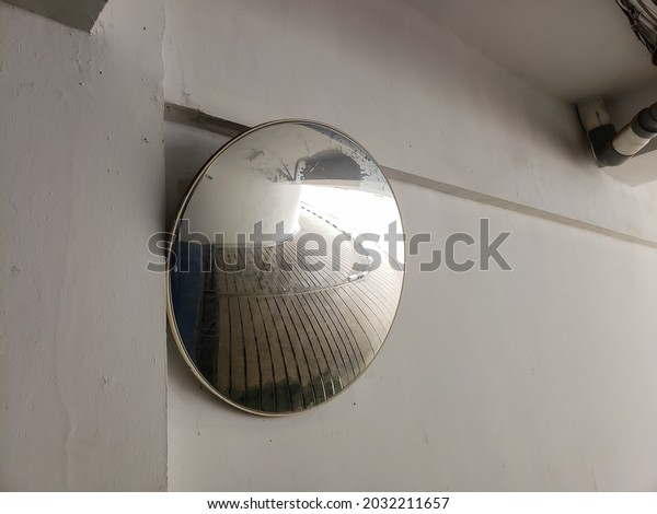 Indoor traffic convex mirror in car parking on\
the morning