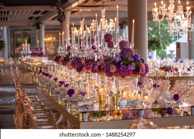 Indoor Wedding Table With Flowers Candles And Chandeliers