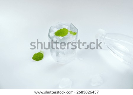 Indoor white background overlooking a translucent glass cup filled with water