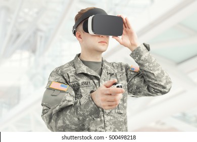 Indoors shot of American soldier wearing virtual reality glasses - Powered by Shutterstock