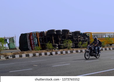 Indore, India - May 2018: Brutal Accident Of A Truck On A Highway. An Overturned Truck Lying On A Highway And A Motorcycle Passing By.