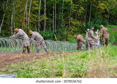 Indra, Latvia - September 28, 2021: Latvia - Belarus border, where Latvian State Border Guard and army begins to install a barbed wire fence.   