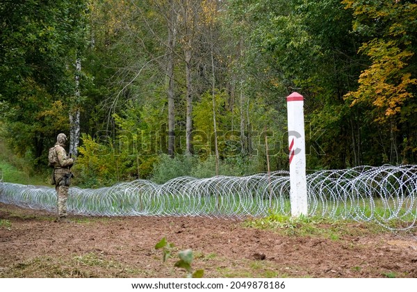 Indra, Latvia - September 28, 2021: Latvia -\
Belarus border, where Latvian State Border Guard and army begins to\
install a barbed wire\
fence