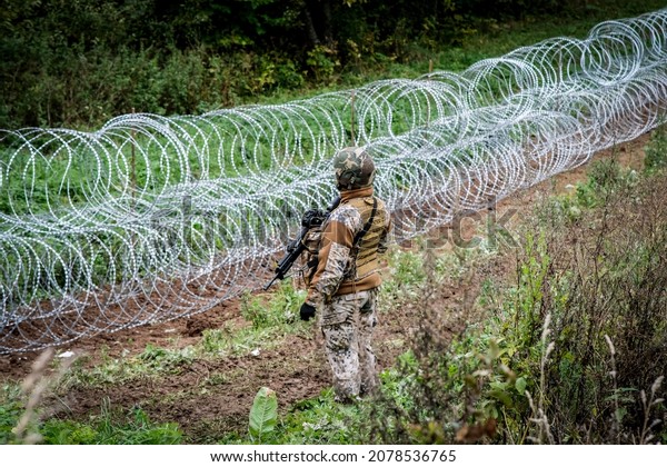Indra, Latvia - September 28, 2021: Latvia - Belarus
border, where Latvian State Border Guard and army begins to install
a barbed wire fence.   