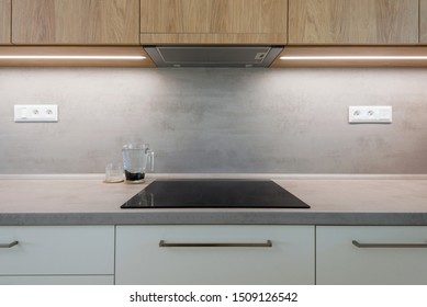 Induction Cook Top On Worktop Of Contemporary Kitchen