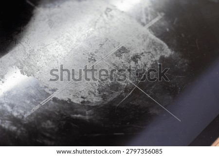 Induction cooktop surface having burnt food residue, grease, and scratch marks requiring cleaning