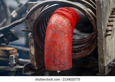 Induction, Crucible Melting Furnace. A Red-hot Metal Pipe Takes The Form Of A Half-branch Under The Influence Of Heat In An Induction Furnace