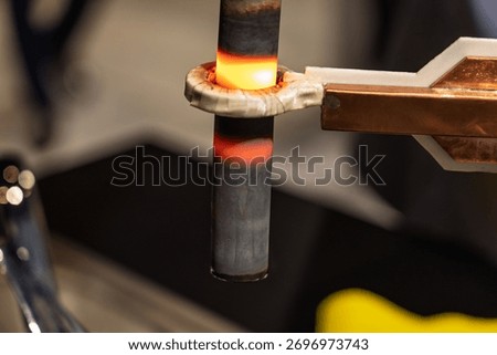 Induction hardening type of surface hardening . Metal part is induction-heated and then quenched. Quenched metal. Induction heating  process. Electromagnetic induction. Surface hardening of steel.