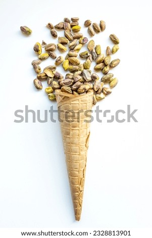 Similar – Ice cream cone with unpeeled peanuts on pink background