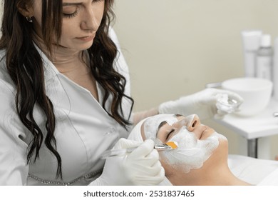 Indulge in a professional facial treatment at a beauty spa, where an esthetician will apply a face mask for rejuvenation. Enjoy the skincare pampering and relaxation at the luxury spa - Powered by Shutterstock