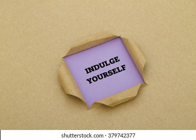 Indulge Yourself Message Written Under Torn Paper. 