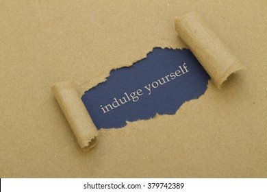 Indulge Yourself Message Written Under Torn Paper. 