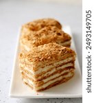 Indulgent Mille-Feuille with crisp, golden layers of puff pastry and creamy custard filling, elegantly topped with crumbled pastry. Napoleon cake