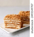 Indulgent Mille-Feuille with crisp, golden layers of puff pastry and creamy custard filling, elegantly topped with crumbled pastry. Napoleon cake