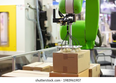 Industrail Robotic Arm Holding Package In An Industry Packaging Line. Industrial 4.0 Technology For Modern Factory Management. Robotic Arm Use With Vacuum System For Packaging Line In A Factory.