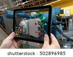 Industrial 4.0 , Augmented reality concept. Hand holding tablet with AR service , maintenance application and calling technician for check destroy part of smart machine in smart factory background