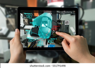 Industrial 4.0 , Augmented reality concept. Hand holding tablet with AR service , Thermal Monitoring motor application for check destroy part of smart machine in smart factory background - Shutterstock ID 551791498