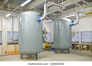 Industrial air compressor tank systems with equipment machinery setup in building utility room at the factory
