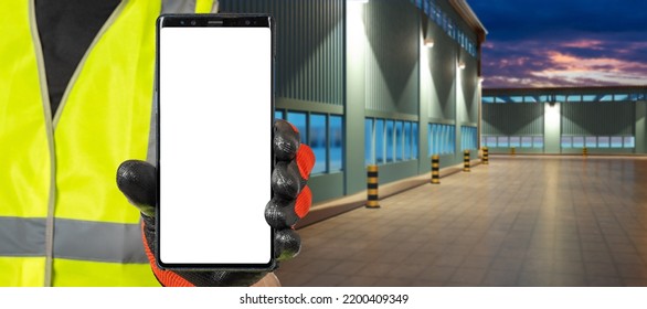 Industrial Application. Mobile Phone In Hands Factory Worker. Man With Phone Near Blurred Factory Building. Smartphone With White Screen. Phone For Industrial Offer. Place For Site Industrial Company