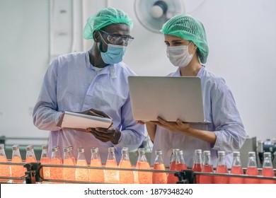 industrial background of beverage factory production line supervisor and worker working together in beverage production line during processing in beverage manufacturing factory - Powered by Shutterstock