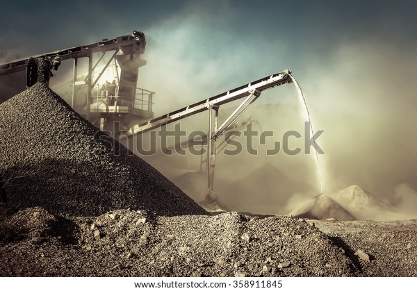 Industrial\
background with working gravel\
crusher