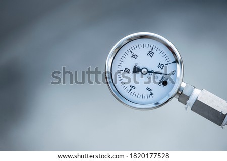 Industrial bar pressure indicator. Air, gas and oil pressure gauge at the factory plant installed on a pipeline.