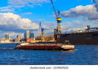 Industrial barge carrying scrap metal for recycling on the river Elbe in Hamburg, Germany